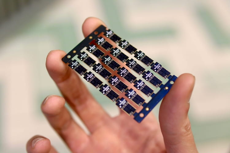 NS_SILICON_WITCHERY-1_WEB.jpg a hand holding a circuit board
