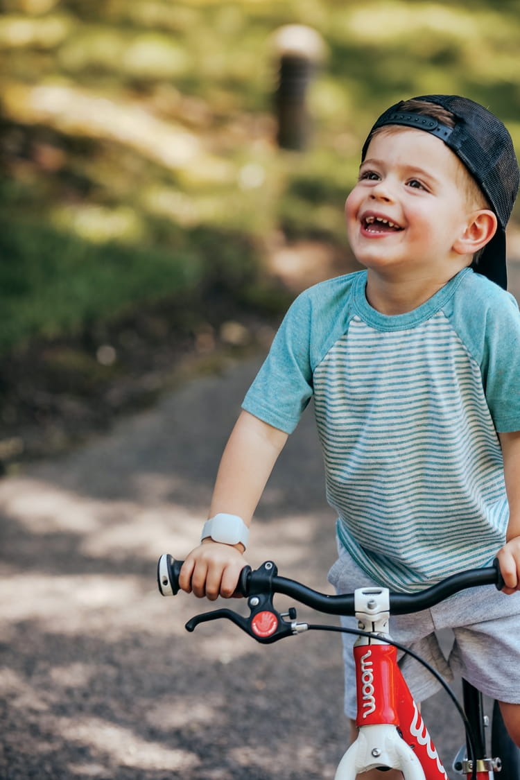 NS_Littlebird-1_WEB.jpg A happy child on a bicycle with the Littlebird CareTracker on their arm