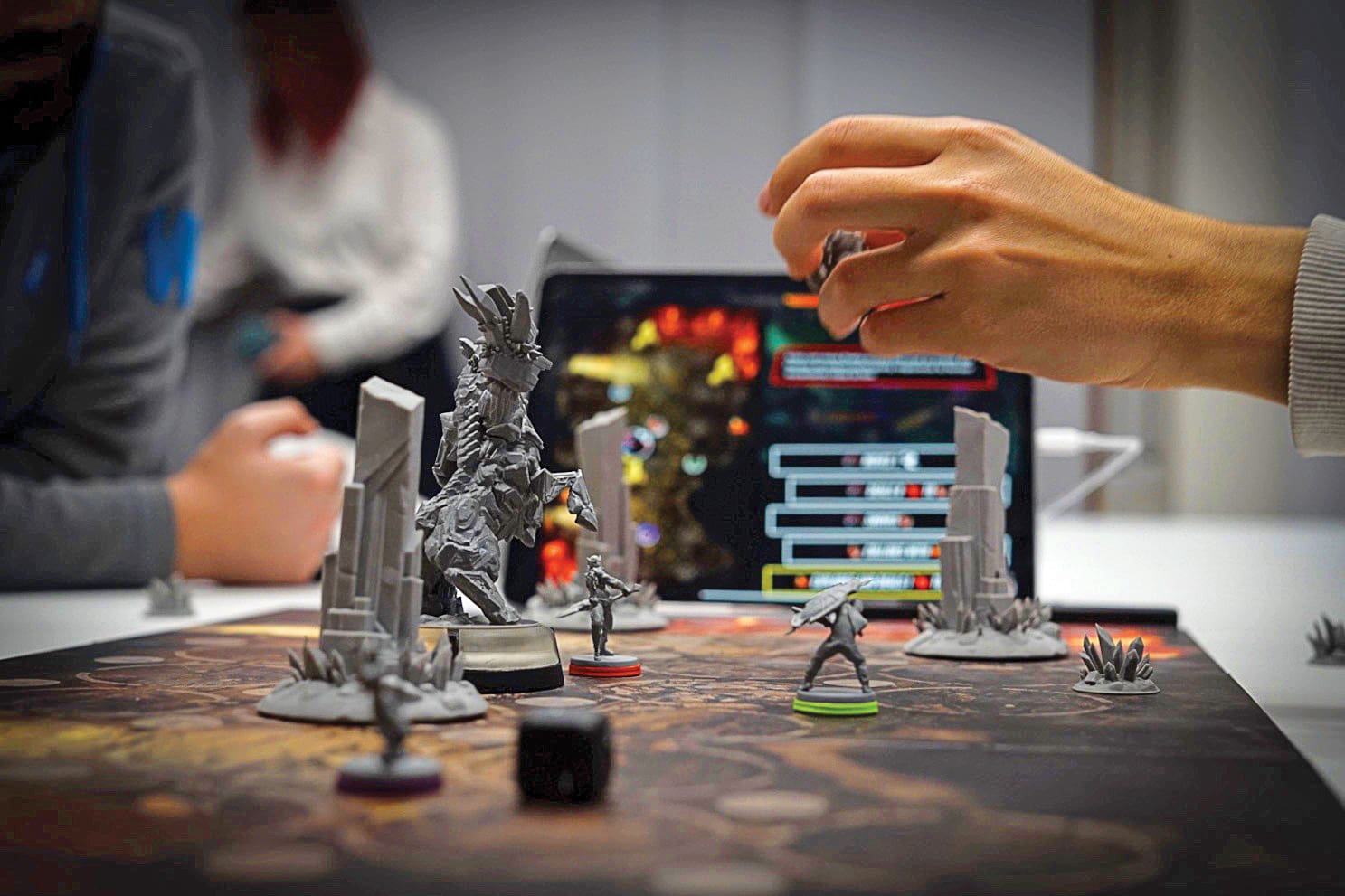 person indoor table man cake front using sitting glasses wine woman holding kitchen laptop counter young computer standing people