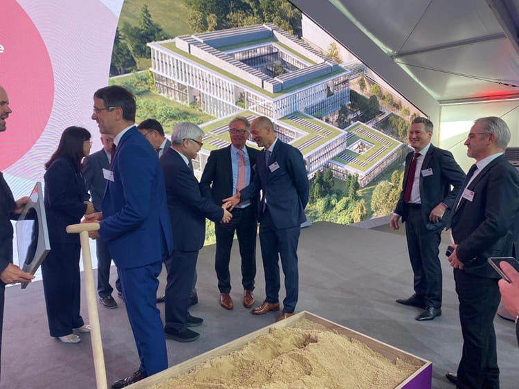 1000072394.jpg a group of people standing in front of a building