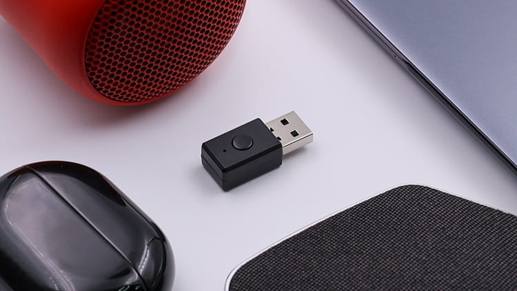 NS_Feasycom.jpg indoor table sitting small piece orange desk mouse computer holding remote