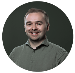 Sam_Presley_circle.png Portrait of man smiling with green pique shirt